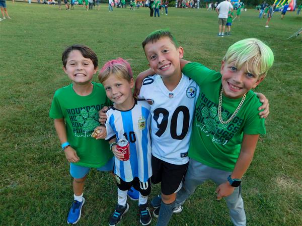 Students outside enjoying a family fun night for their school.